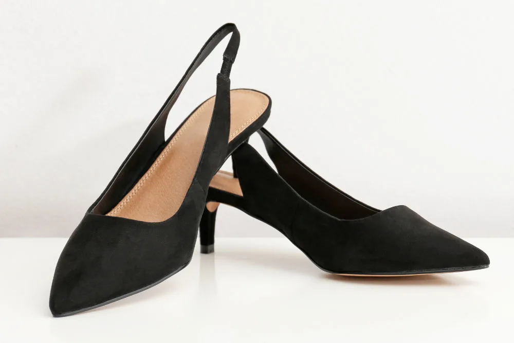 Pair of women's slick back heels shoes against white background.