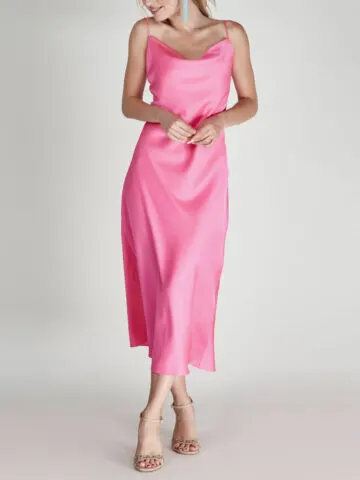 Woman wearing pink dress with nude shoes.