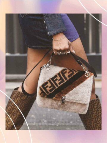 Cropped view of woman wearing a short dress with boots holding a furry Fendi purse.