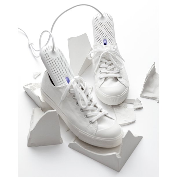 Portable shoe dryer inside white sneakers.