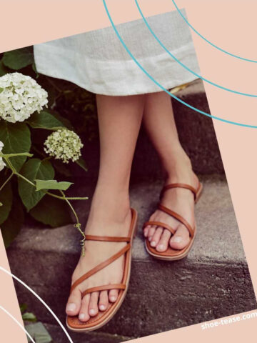 Close up of woman's feet on stairs wearing brown strappy slides outfit with white dress hem next to white flowers.