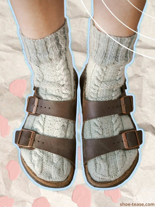 Close up of woman wearing brown birkenstocks with socks that are grey cable knit.