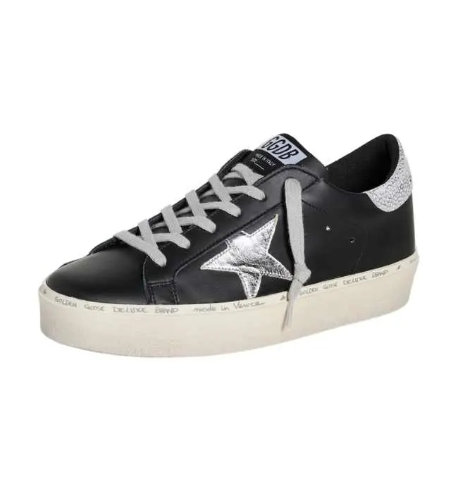 One Black Golden Goose Hi star sneakers with silver star on white background.