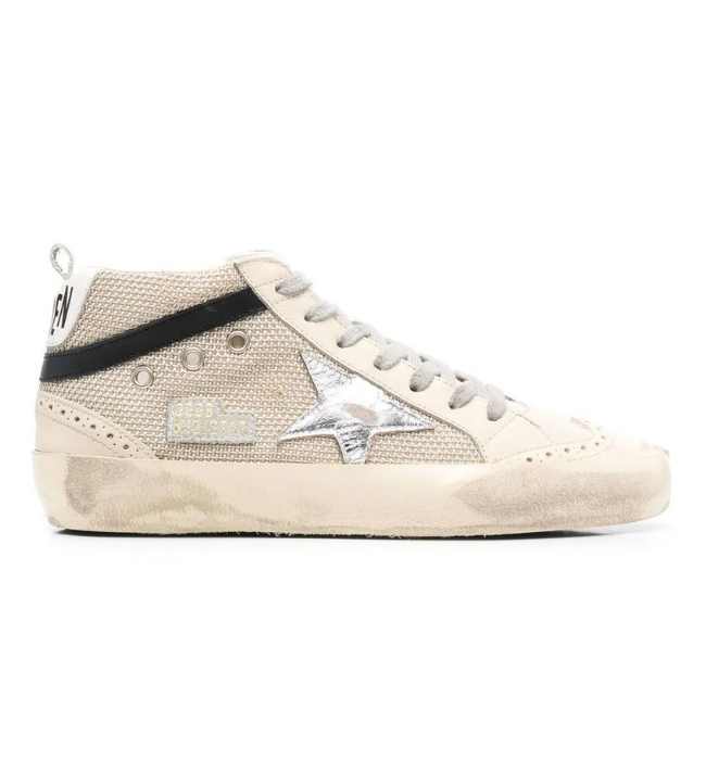 One white Golden Goose high top star sneakers with black star sneakers on silver background.