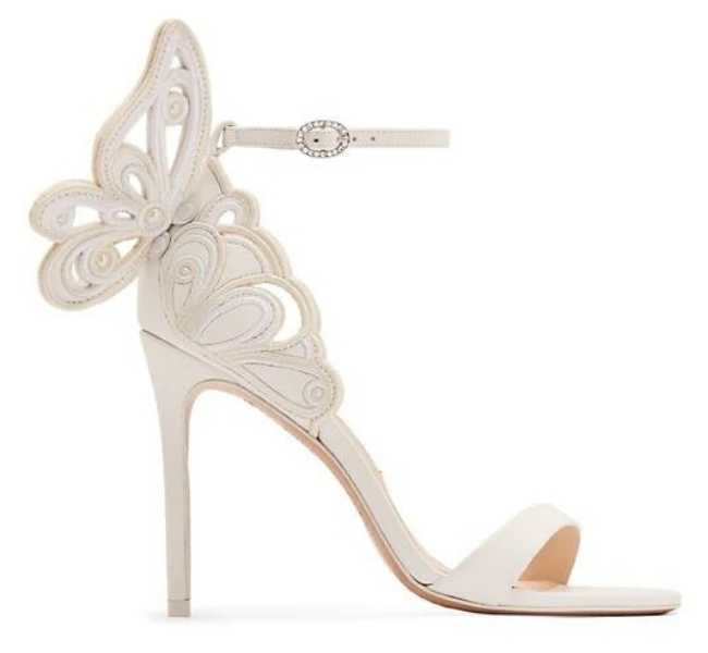White satin wedding sandals with unique butterfly back heel detail on white background.