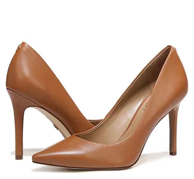 Brown leather pointed toe pumps on white background.
