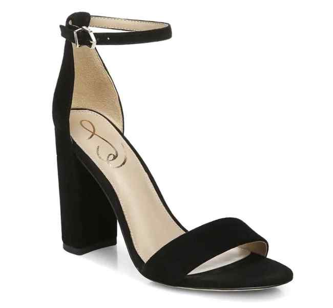 Black suede block heel sandals on white background.