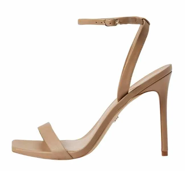 Beige leather stiletto heel sandals on white background.