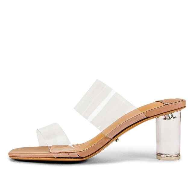 Clear PVC strappy mules with clear heels on white background.