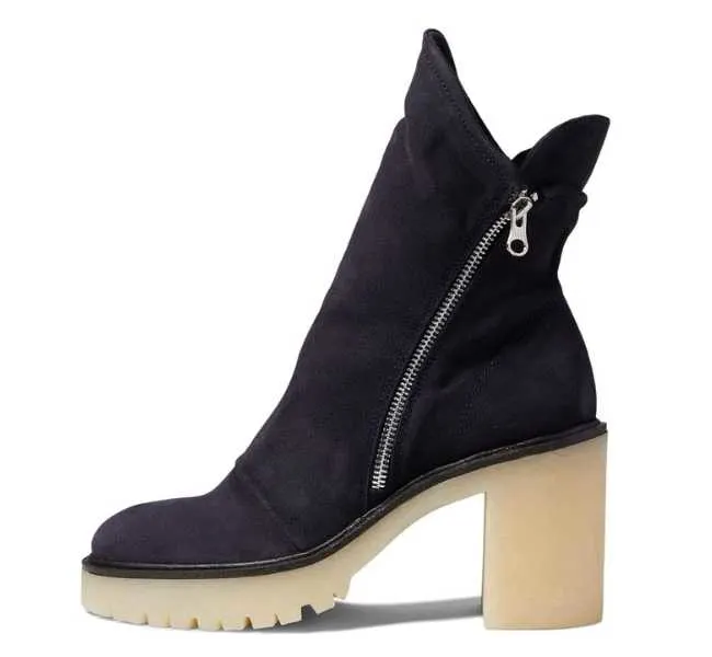 Black upper off-white sole chunky ankle boot on white background.