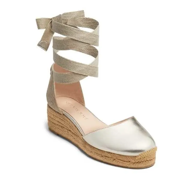 Platinum closed toe ankle wrap espadrille mid wedge heel on white background.
