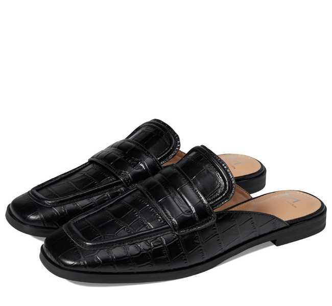 Black textured leather square toe slip on loafers on white background.