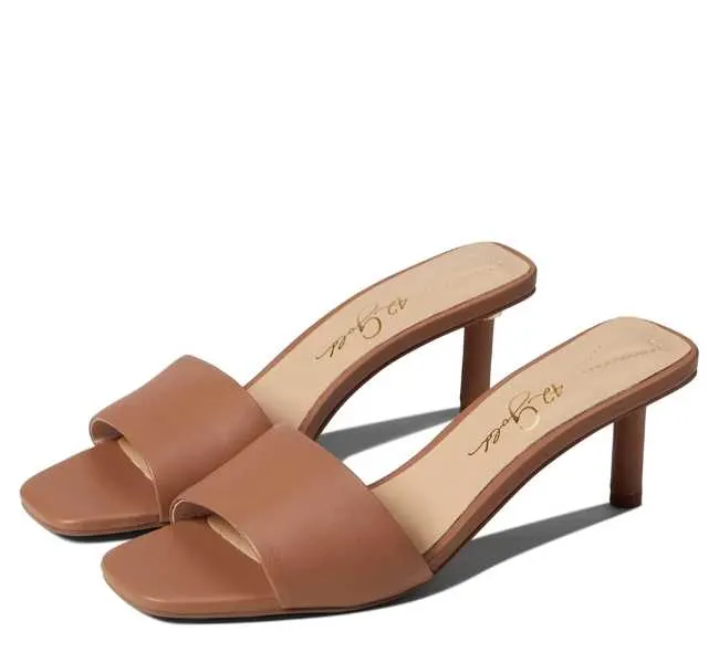 Tan open square toe heeled slip on sandals on white background.