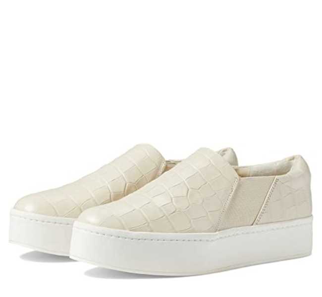 Beige textured slip on sneaker on white background.