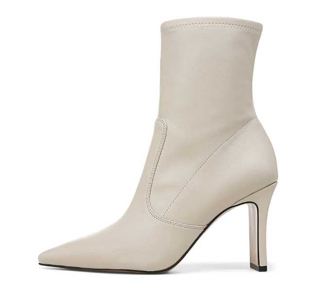 White pointed toe ankle length sock boot on white background.