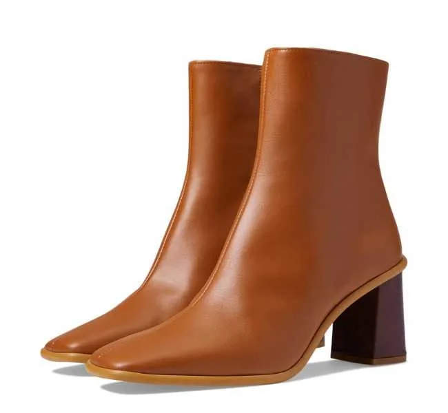 Tan leather square toe heeled boots now white background.