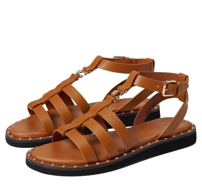Brown leather slip on open toe adjustable ankle strap with buckle closure sandal on white background.