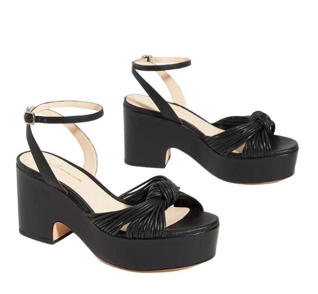 Black leather knotted open toe design with buckle ankle strap heels on white background.