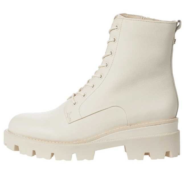 White lace up combat boot on white background.