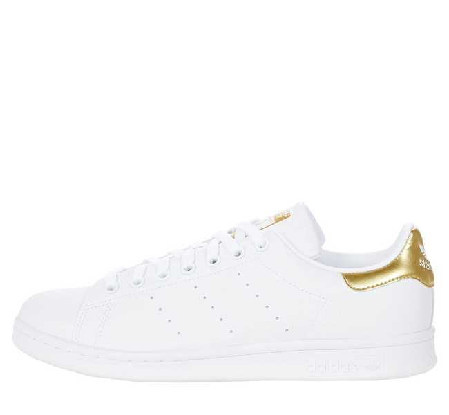 White with gold heel tab lace up sneaker on white background.