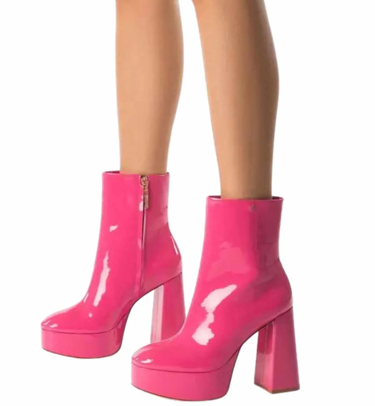 Woman's legs in Hot Pink Barbie Core Fashion Patent Platform Booties on white background.