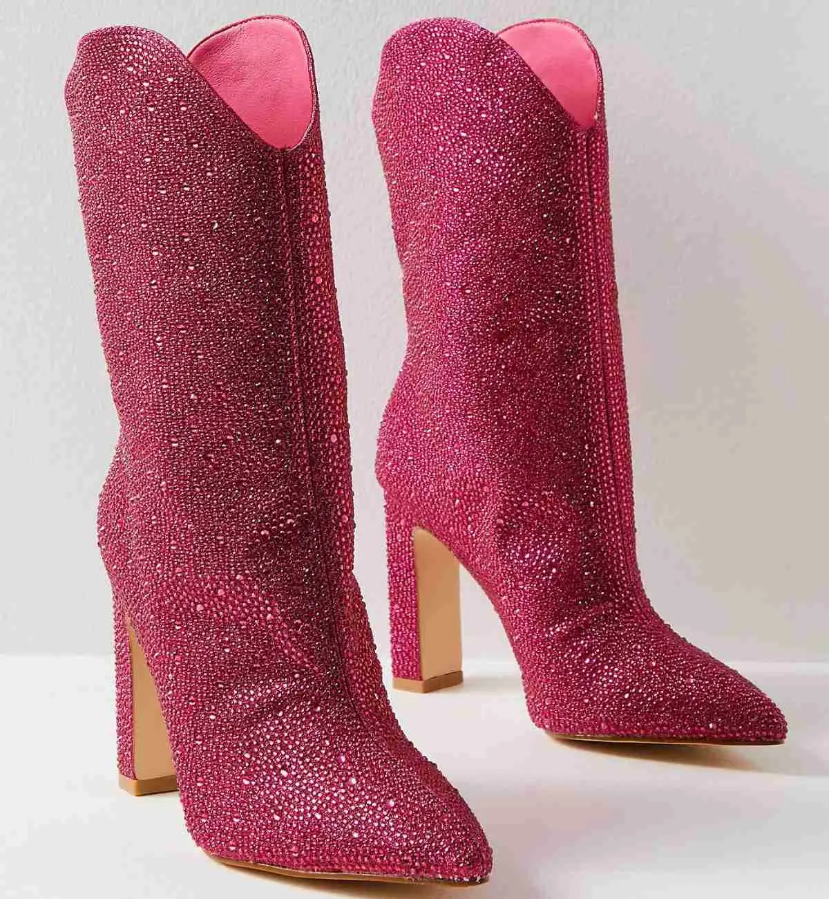 Hot Pink Barbie Core Fashion western sparkly high heel booties with on white background.