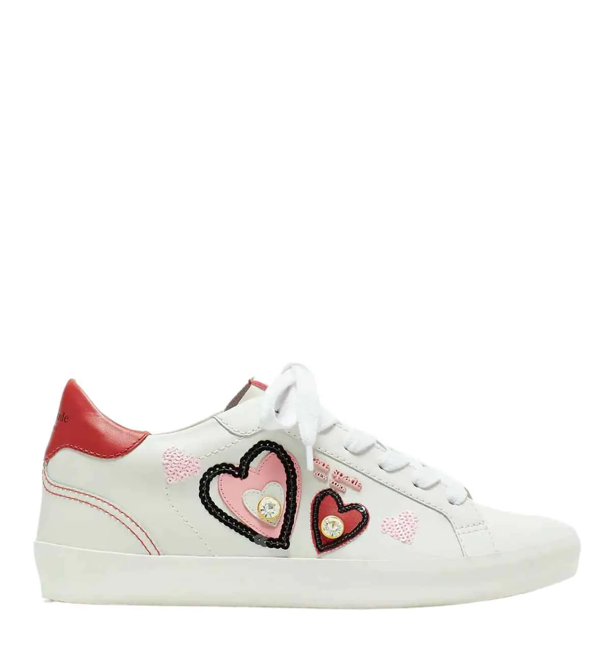 White heart sneaker with various textured heart on the side with white laces on white background.