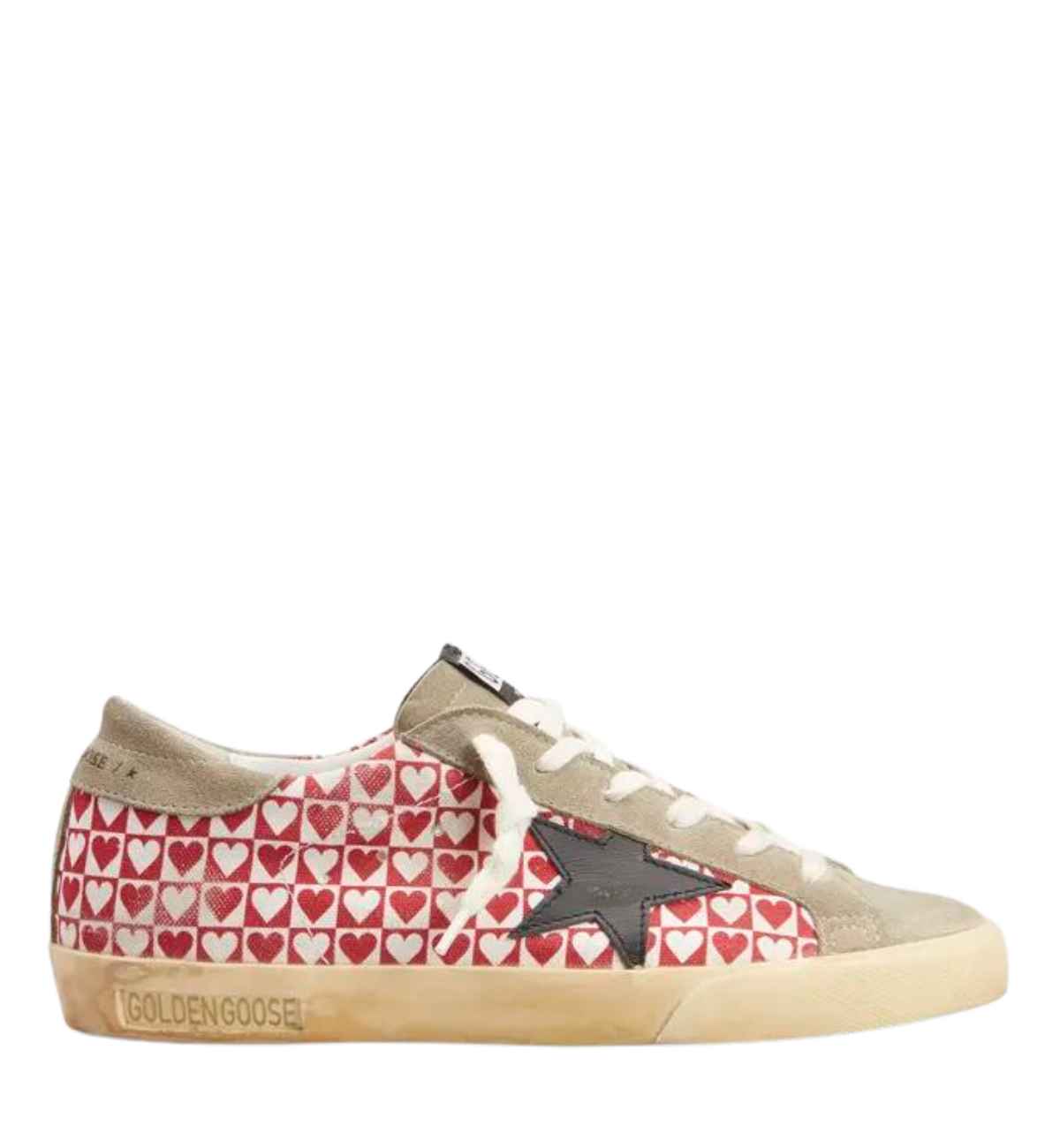 Golden goose heart sneaker with red and white checkered heart pattern all over on white background.