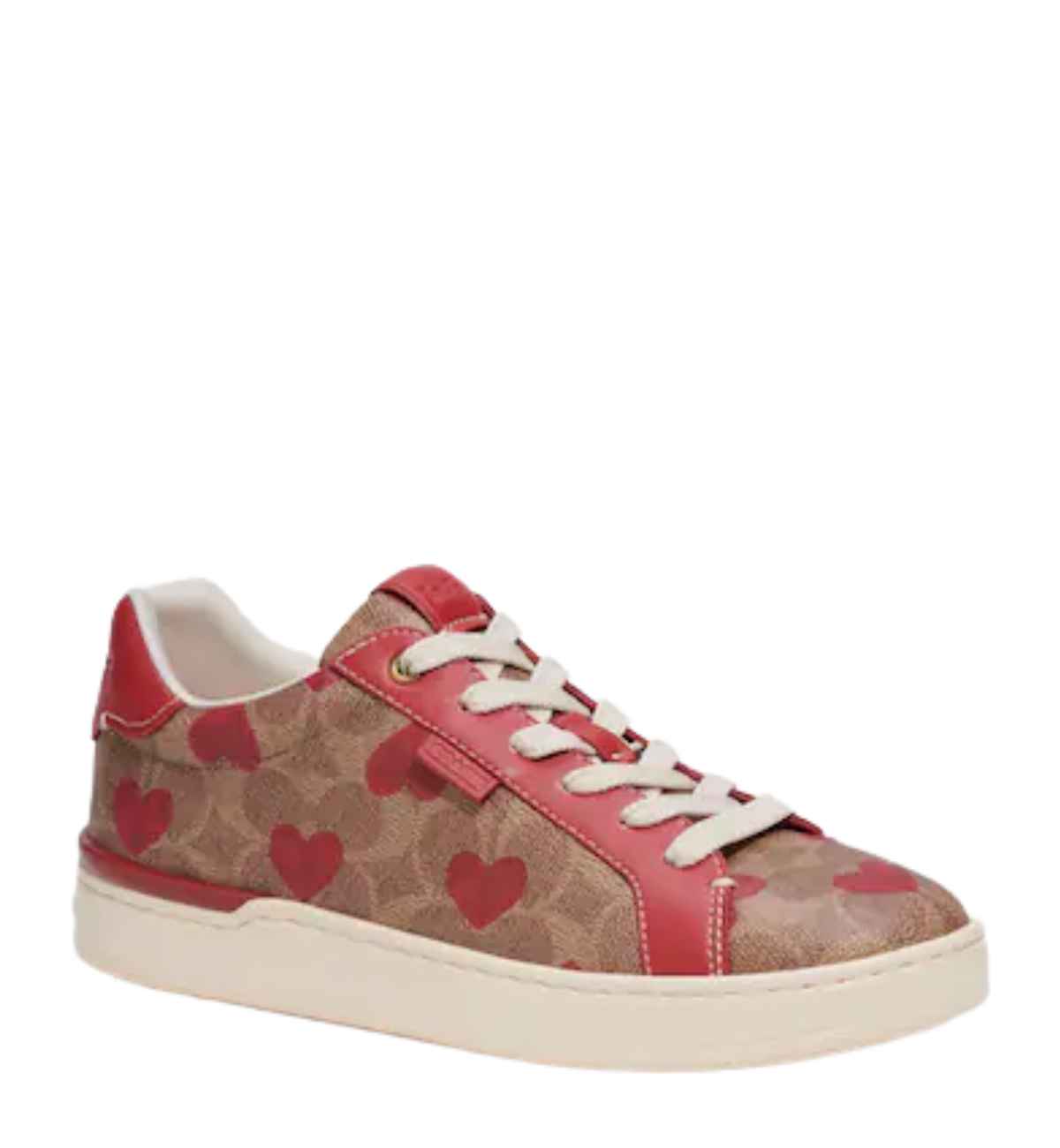Brown sneaker with heart pattern all over on white background.