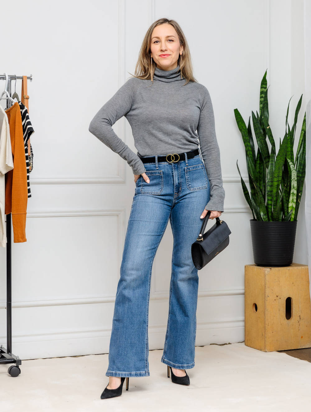 Woman wearing flare jeans with pointed toe ankle boots for fall/winter.