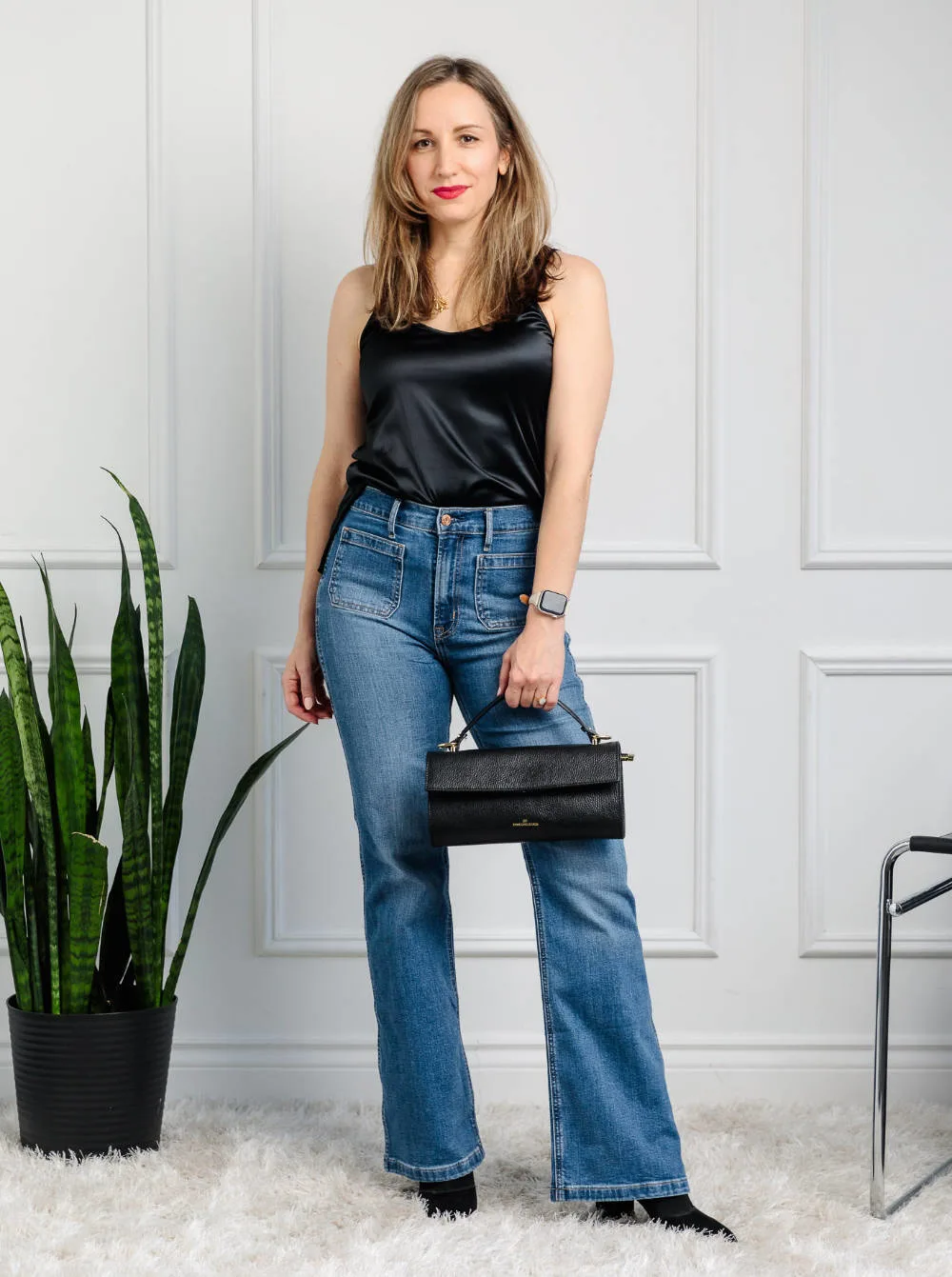 Woman wearing flare jeans with pointed toe ankle boots for fall/winter.