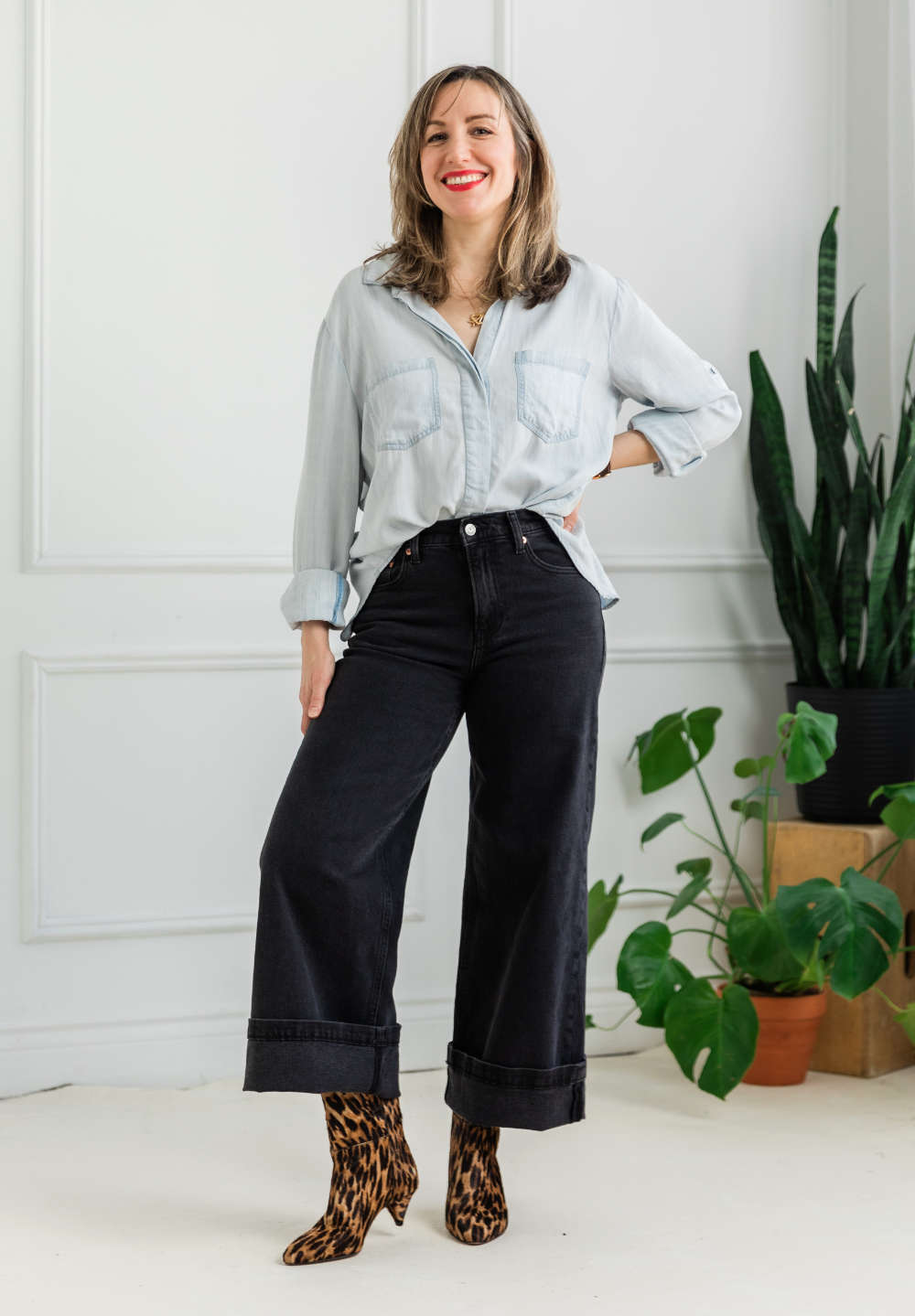 Woman wearing cuffed wide leg jeans outfit with leopard print calf boots.