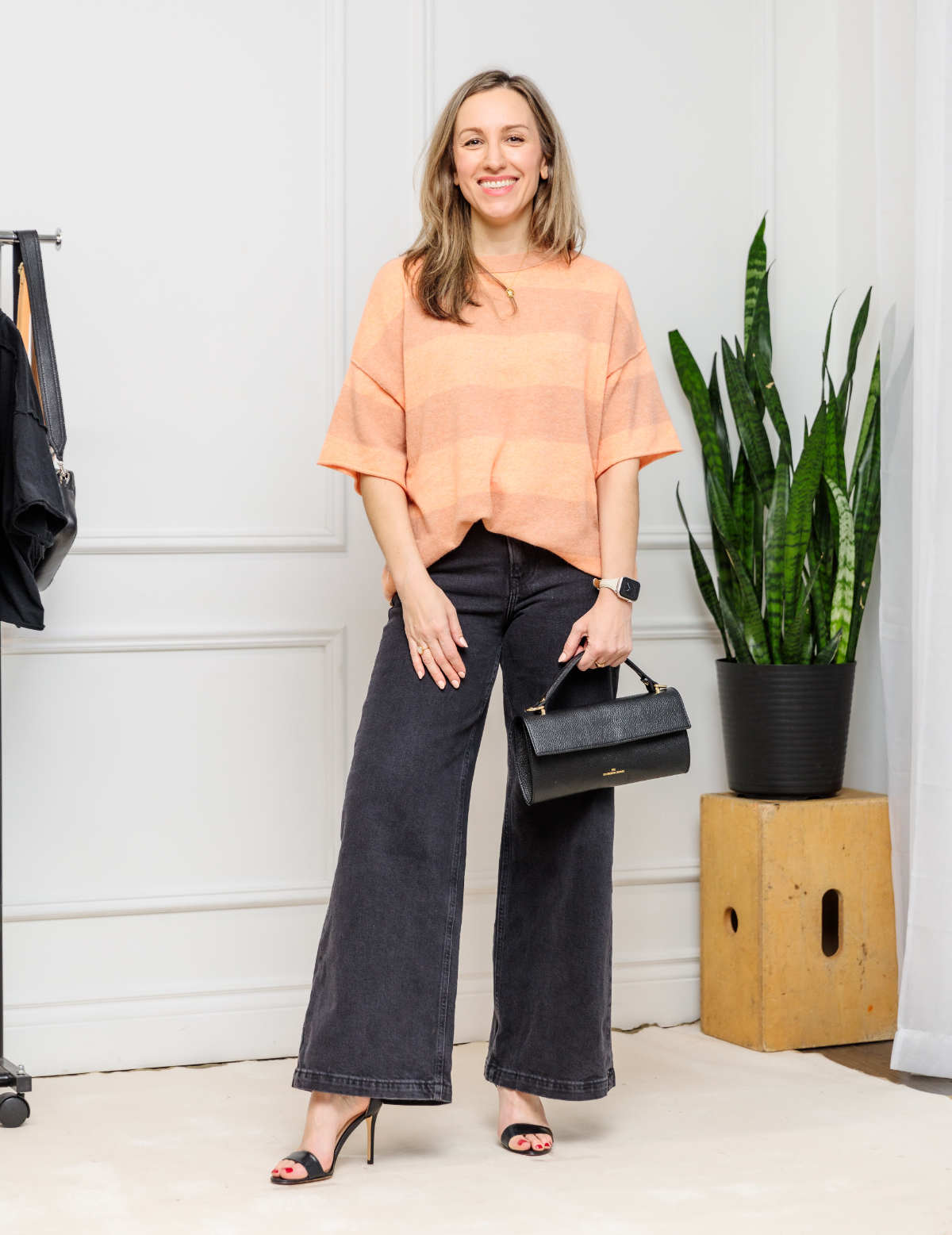 Woman wearing wide leg jeans outfit high heel sandals.