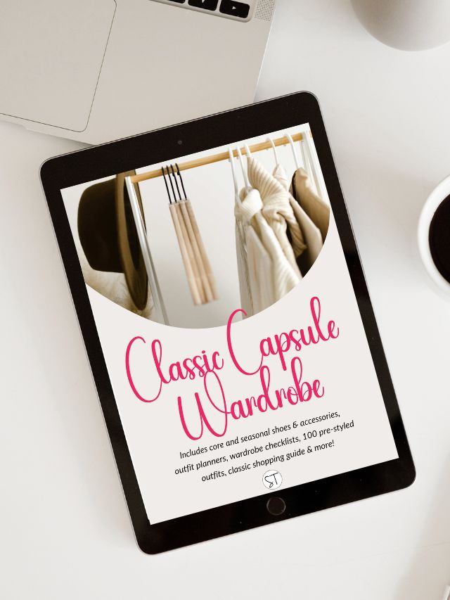 Ipad featuring the front page of an ebook titled classic capsule wardrobe on a white desk background.